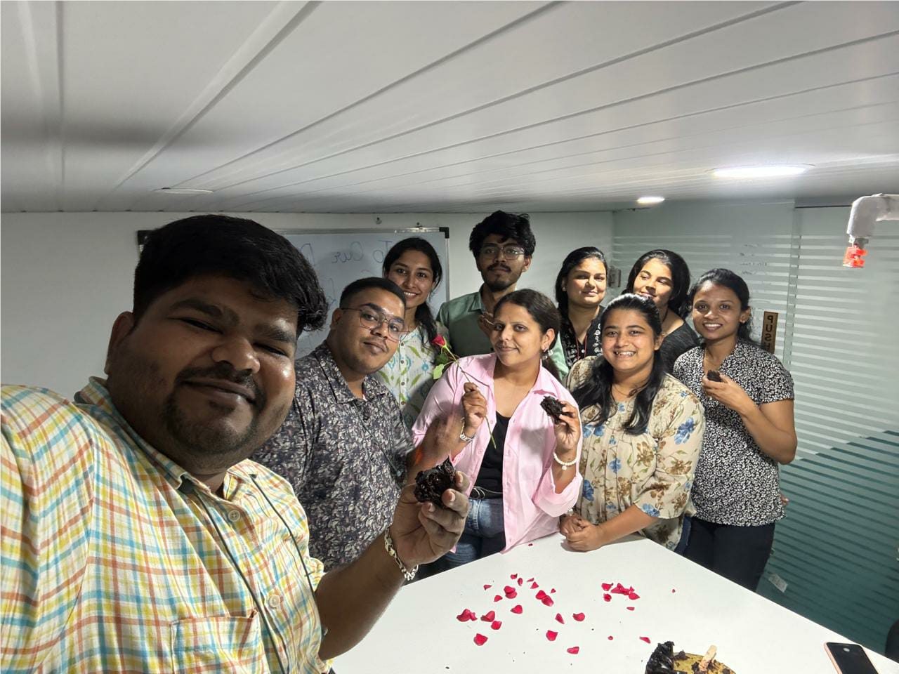 TechnoEdge colleagues taking a group selfie during a celebration