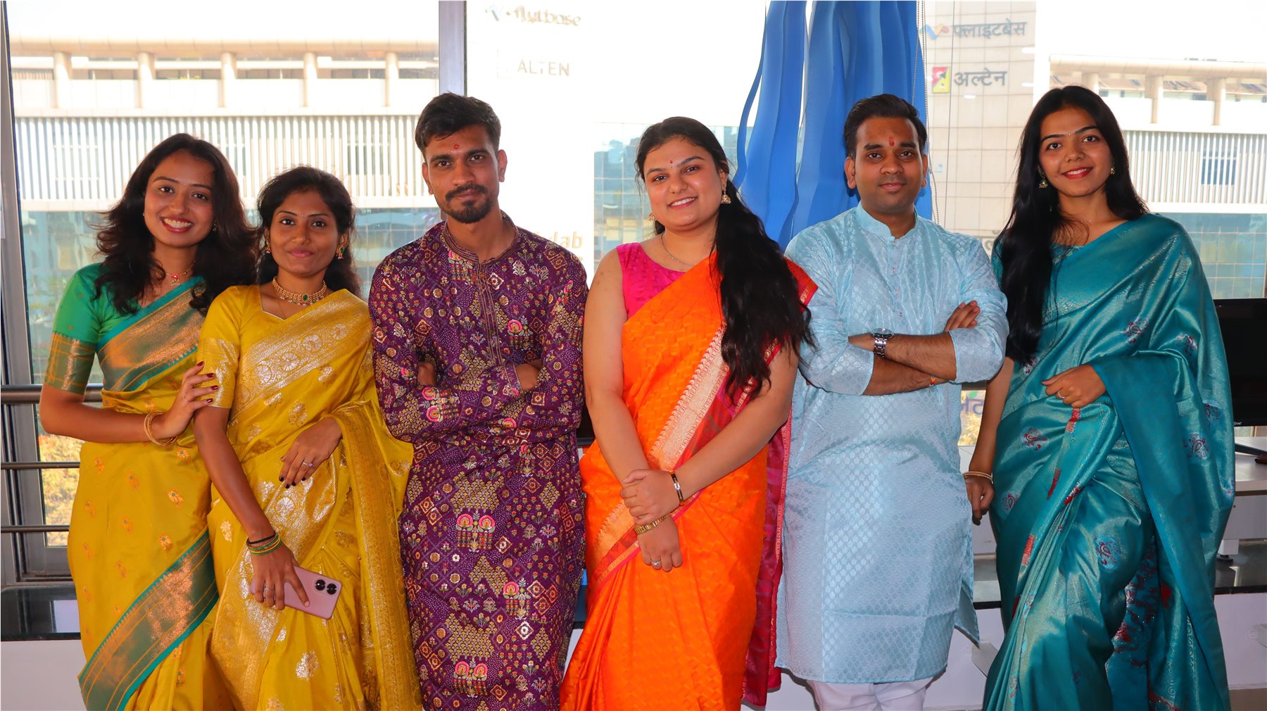 TechnoEdge colleagues in traditional attire during a workplace celebration