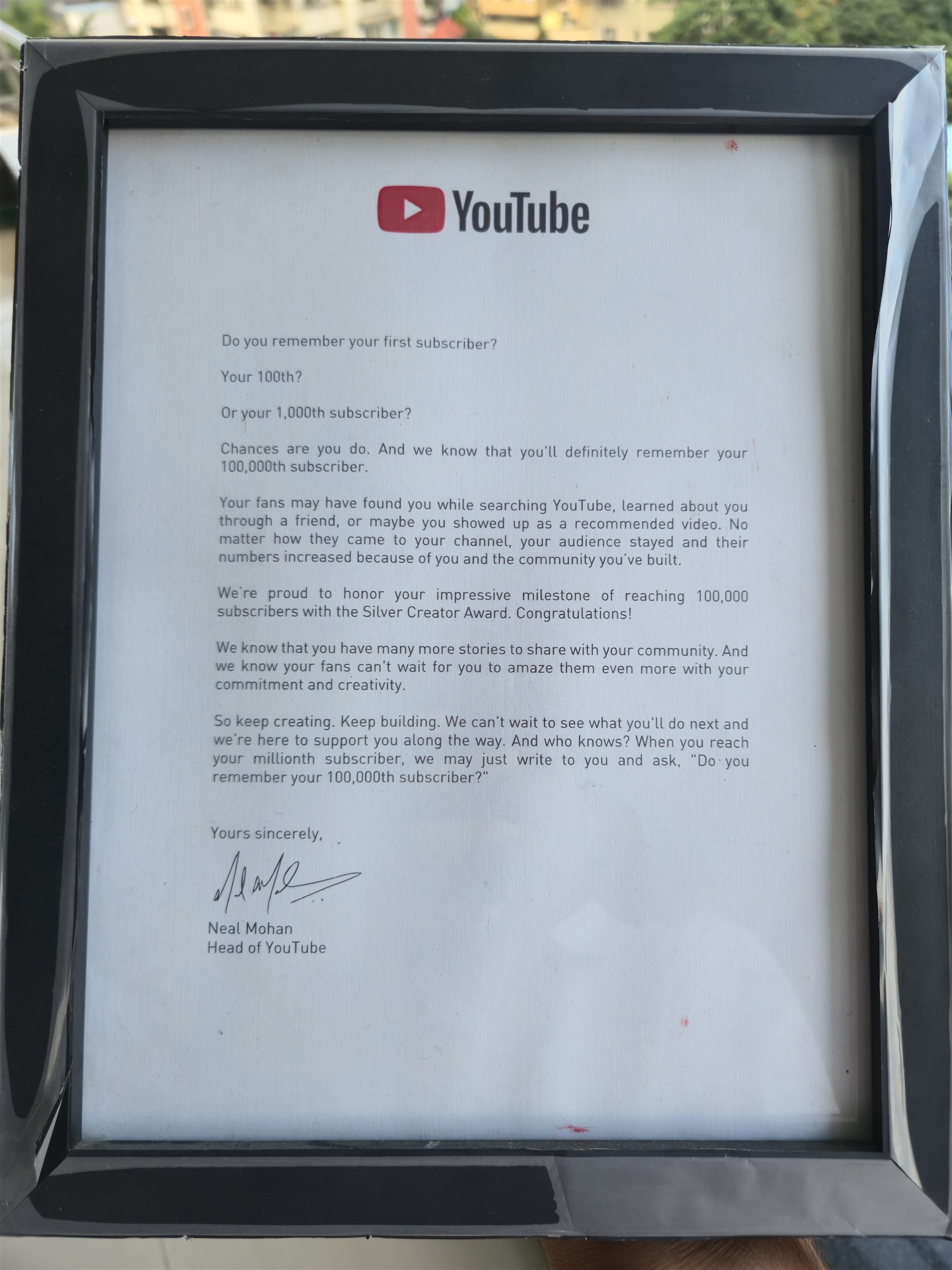 Framed letter from YouTube recognising the 100,000-subscriber milestone