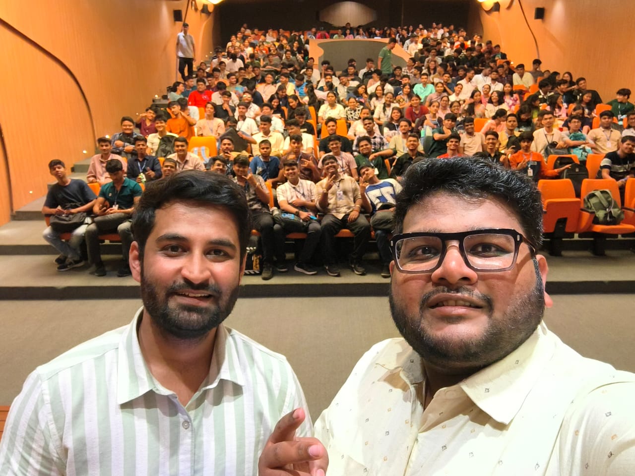 Trainers and a large auditorium audience after a session